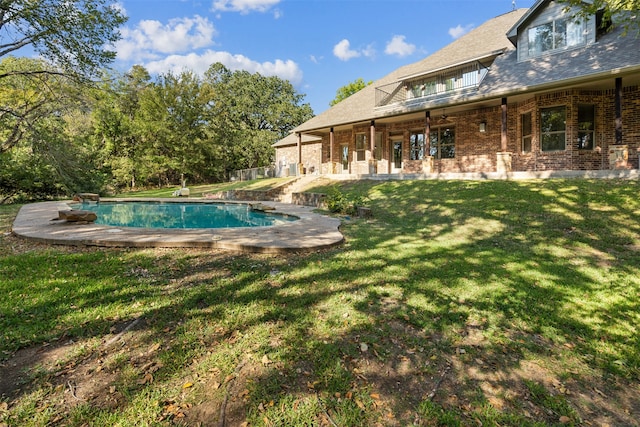 view of swimming pool featuring a yard and a patio area