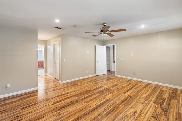 empty room with light hardwood / wood-style floors and ceiling fan