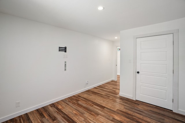 empty room featuring dark hardwood / wood-style flooring