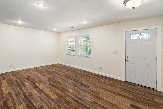 foyer featuring dark wood-type flooring and a textured ceiling