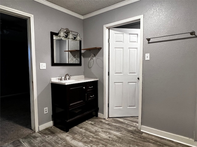 bathroom featuring vanity, hardwood / wood-style floors, and crown molding