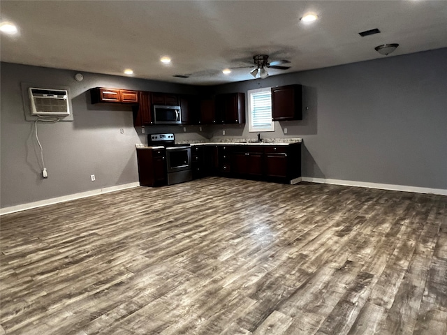 kitchen with appliances with stainless steel finishes, sink, wood-type flooring, and ceiling fan