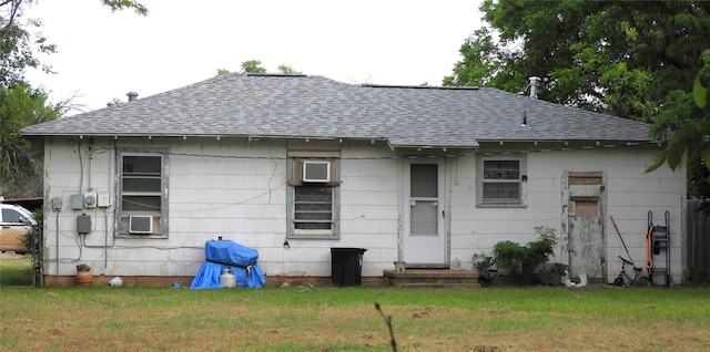 rear view of property with cooling unit and a lawn