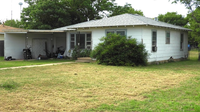 back of house featuring a yard