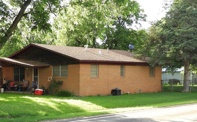 view of side of property featuring a yard