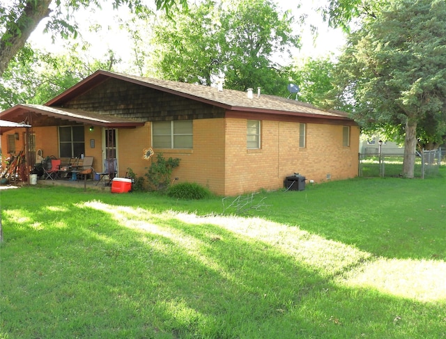 back of property featuring a yard and a patio