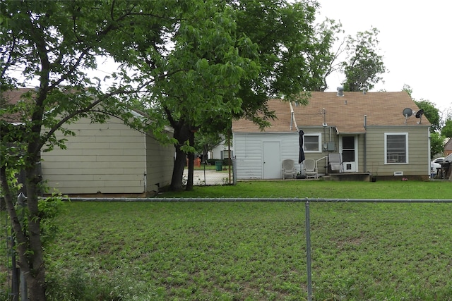 rear view of house featuring a lawn