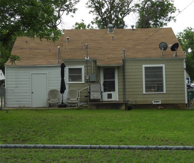 rear view of house with a yard