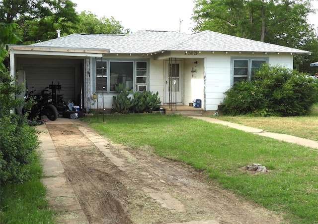 ranch-style house with a front yard and a garage