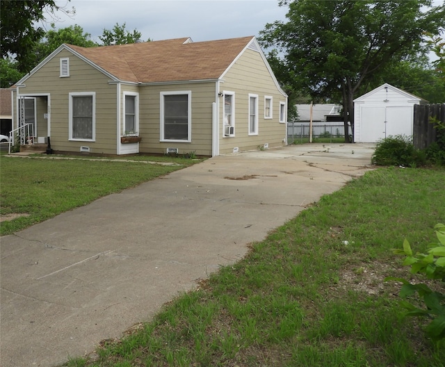 view of front of house with cooling unit and a front lawn