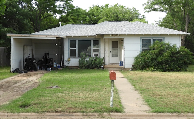 single story home featuring a front lawn and a carport