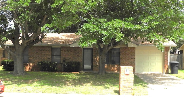 view of front of house with a front yard and a garage