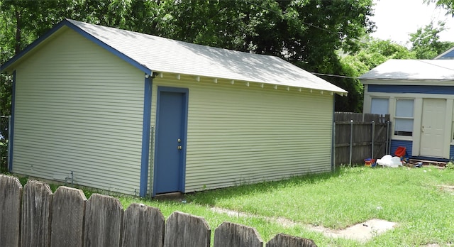 view of outbuilding featuring a lawn