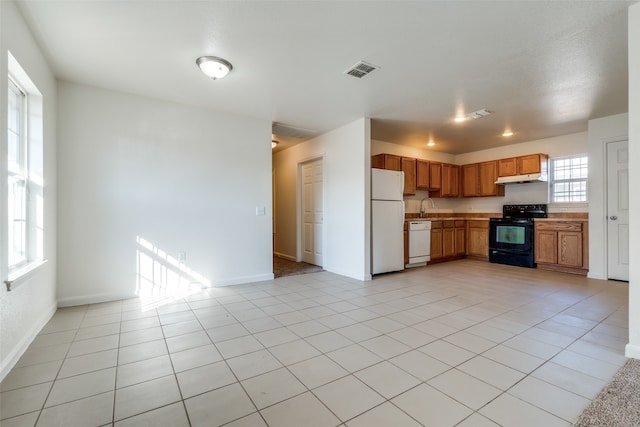 kitchen featuring sink, white appliances, and light tile patterned floors