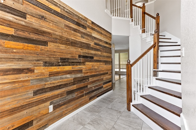 staircase with wood walls