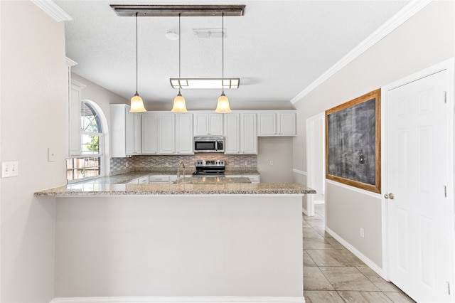 kitchen featuring decorative backsplash, kitchen peninsula, decorative light fixtures, appliances with stainless steel finishes, and a textured ceiling