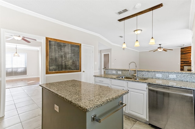 kitchen featuring dishwasher, a kitchen island, sink, light stone countertops, and white cabinetry