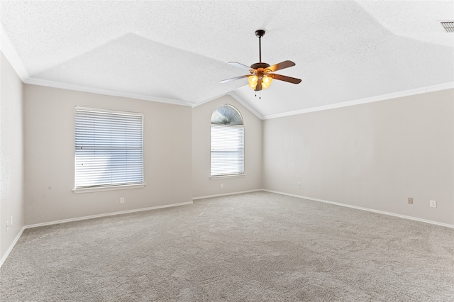 carpeted spare room featuring lofted ceiling, crown molding, a textured ceiling, and ceiling fan