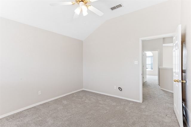 carpeted spare room featuring ceiling fan and lofted ceiling