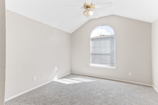 carpeted spare room featuring ceiling fan, a textured ceiling, and lofted ceiling