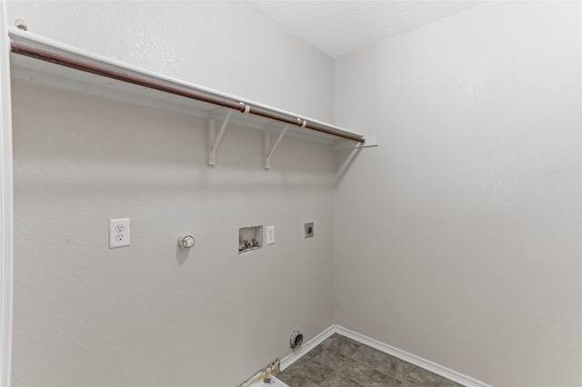 clothes washing area with a textured ceiling, electric dryer hookup, gas dryer hookup, and washer hookup