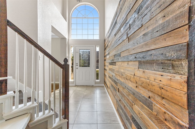 tiled foyer featuring a towering ceiling