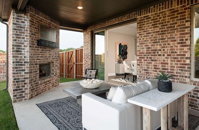 view of patio featuring an outdoor brick fireplace