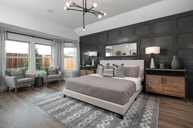 4127 Olmsted Dr, Rockwall, TX 75032 - bedroom with lofted ceiling, dark hardwood / wood-style flooring, and a chandelier