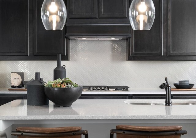 4127 Olmsted Dr, Rockwall, TX 75032 - kitchen with a kitchen breakfast bar, custom range hood, sink, and light stone counters