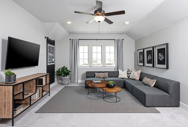 4127 Olmsted Dr, Rockwall, TX 75032 - living room with ceiling fan, a barn door, vaulted ceiling, and light colored carpet