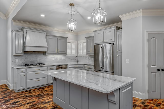 kitchen with gray cabinets, a center island, stainless steel appliances, and sink