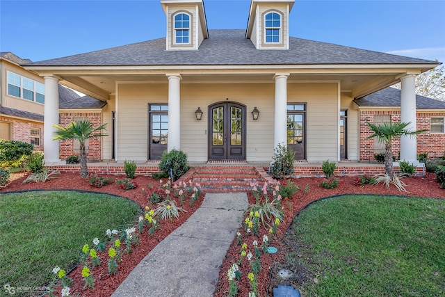 view of front of home featuring covered porch and a front lawn