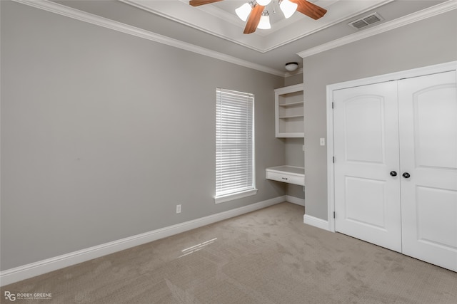 unfurnished bedroom with a closet, ceiling fan, ornamental molding, and light colored carpet