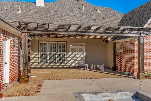 rear view of property featuring a pergola and a patio