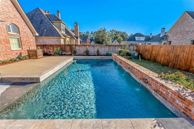 view of pool with pool water feature and a patio area