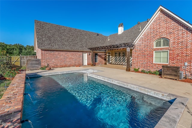 view of swimming pool with a patio and pool water feature