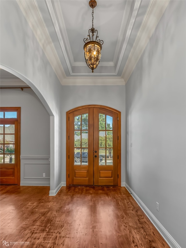 entryway featuring french doors, an inviting chandelier, plenty of natural light, and dark hardwood / wood-style floors