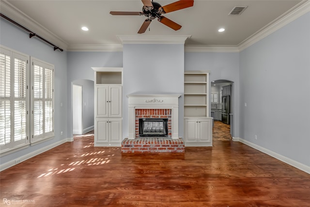 unfurnished living room with crown molding, a fireplace, and dark hardwood / wood-style floors