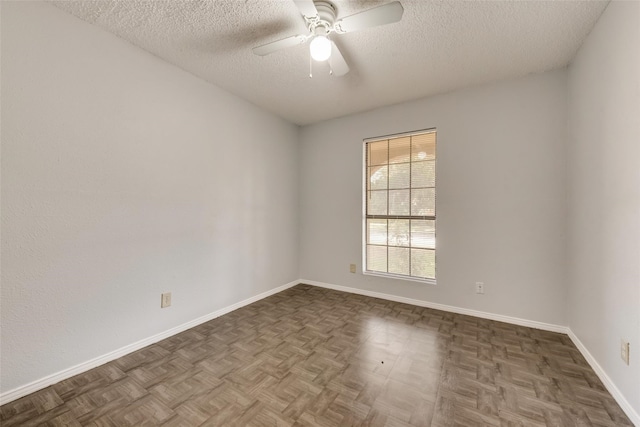 unfurnished room featuring ceiling fan, a textured ceiling, and dark parquet floors