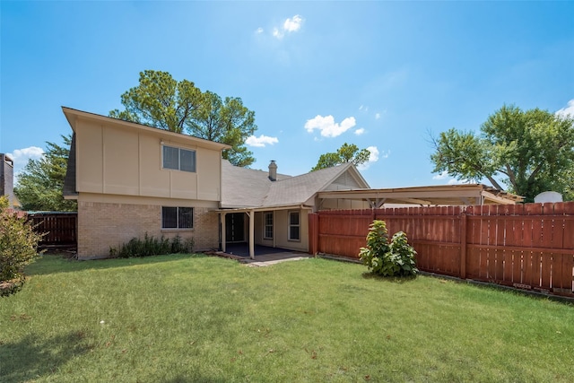 rear view of property featuring a patio and a lawn