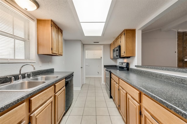 kitchen featuring a textured ceiling, black appliances, sink, and light tile patterned flooring