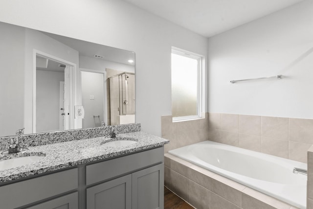 bathroom with hardwood / wood-style flooring, vanity, and independent shower and bath