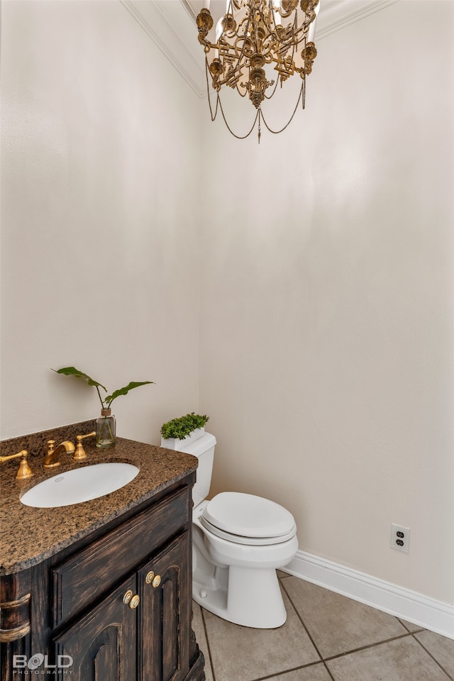 bathroom featuring vanity, toilet, ornamental molding, and tile patterned flooring