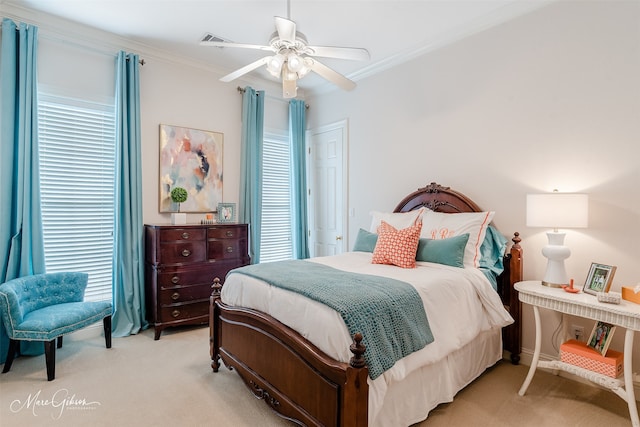 bedroom featuring crown molding, light carpet, and ceiling fan