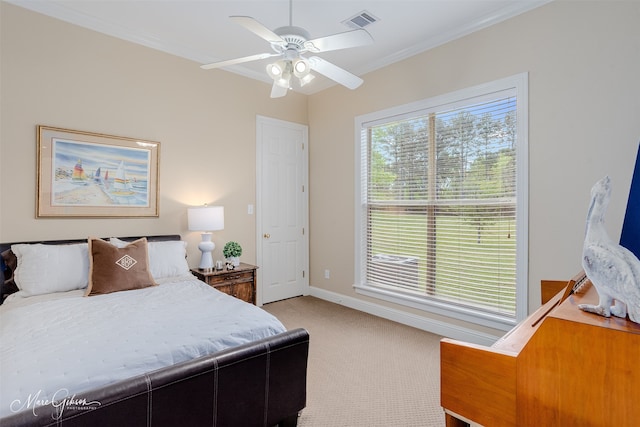 carpeted bedroom featuring ornamental molding and ceiling fan