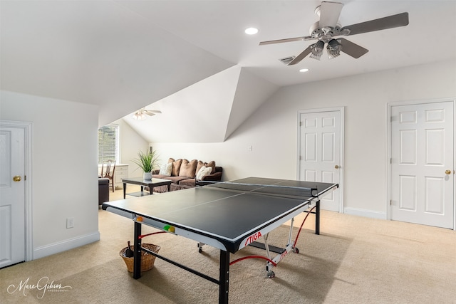 rec room with ceiling fan, vaulted ceiling, and light colored carpet