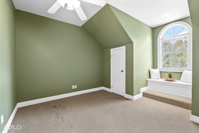 additional living space with carpet flooring, vaulted ceiling, and ceiling fan