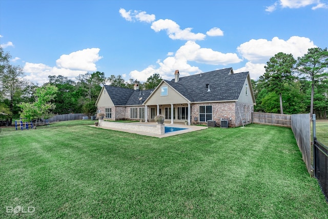 back of house with a patio, a lawn, and central AC unit