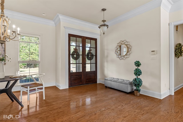 entrance foyer with ornamental molding, french doors, and wood-type flooring