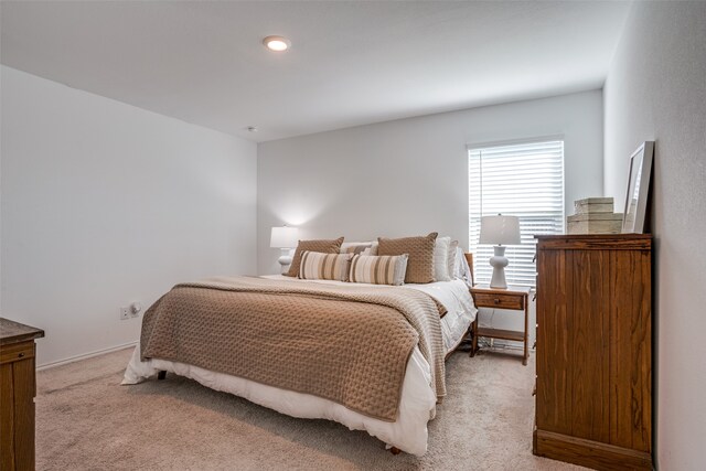 bedroom featuring light carpet